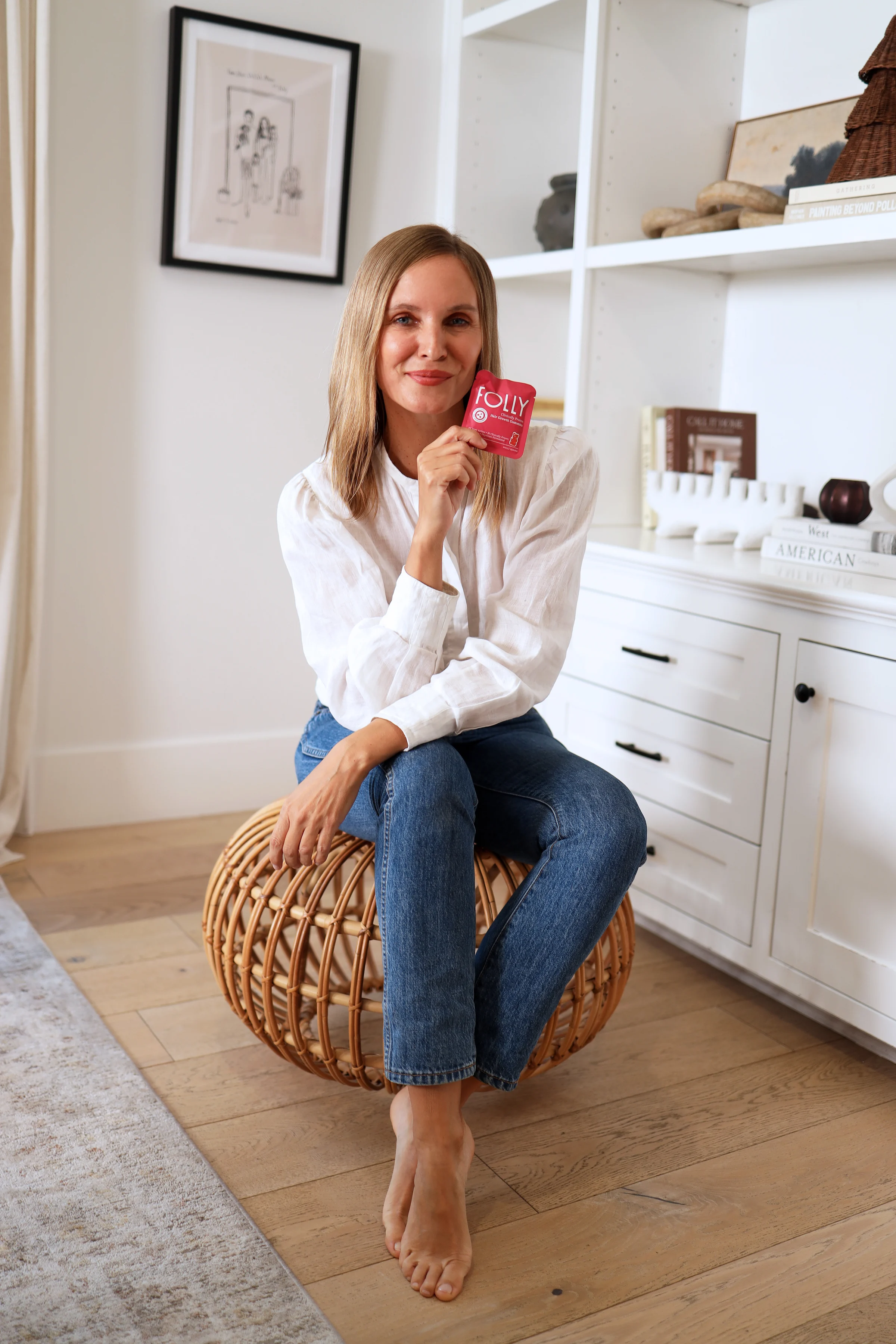 Folly customer holding a Folly pouch at home