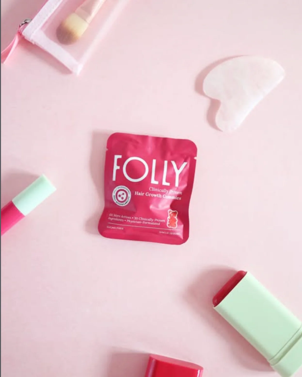 Folly sachet styled with pink beauty accessories
